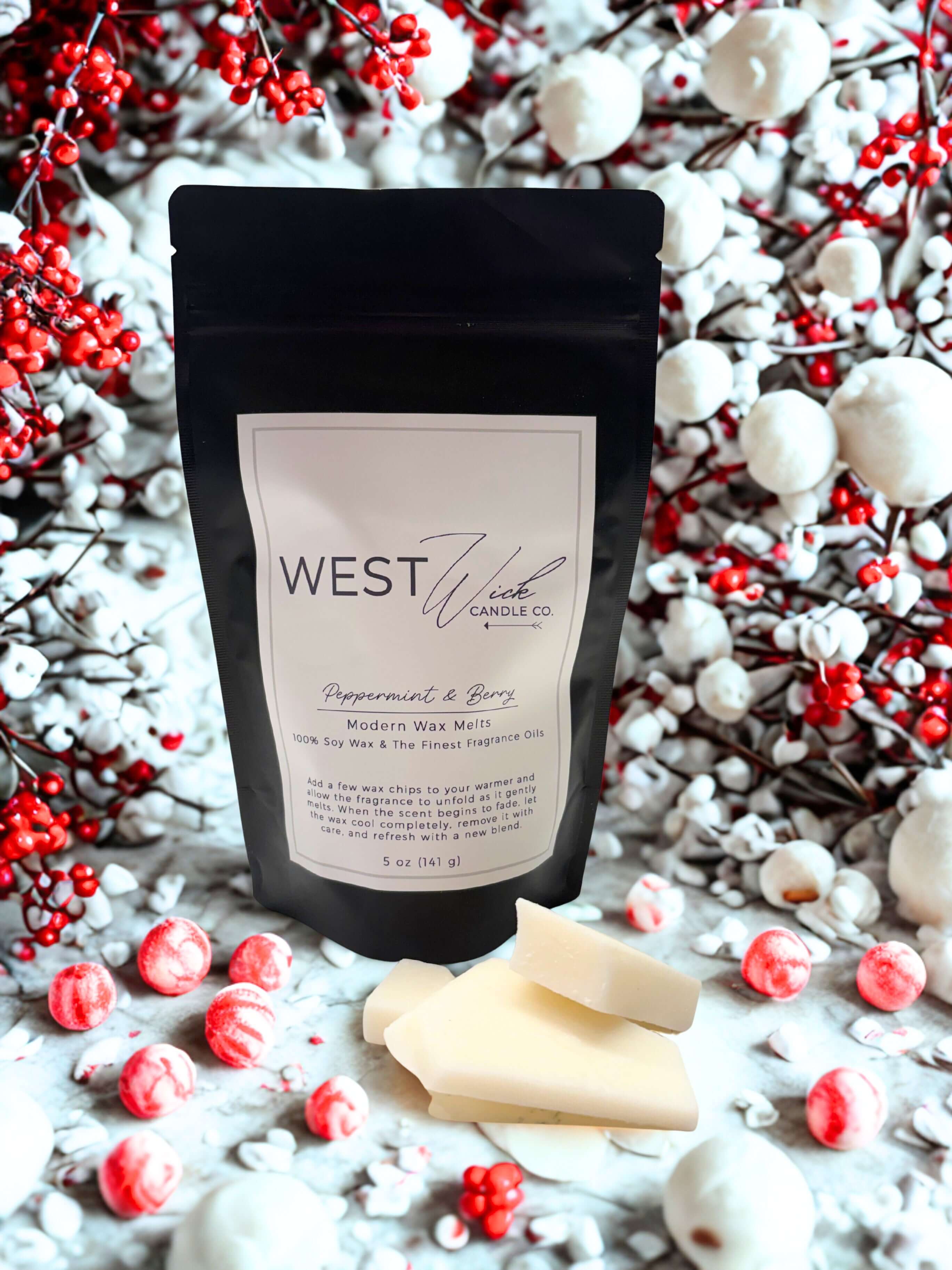 Peppermint & Berry Wax Melts in a package surrounded by festive berries and peppermint candies.