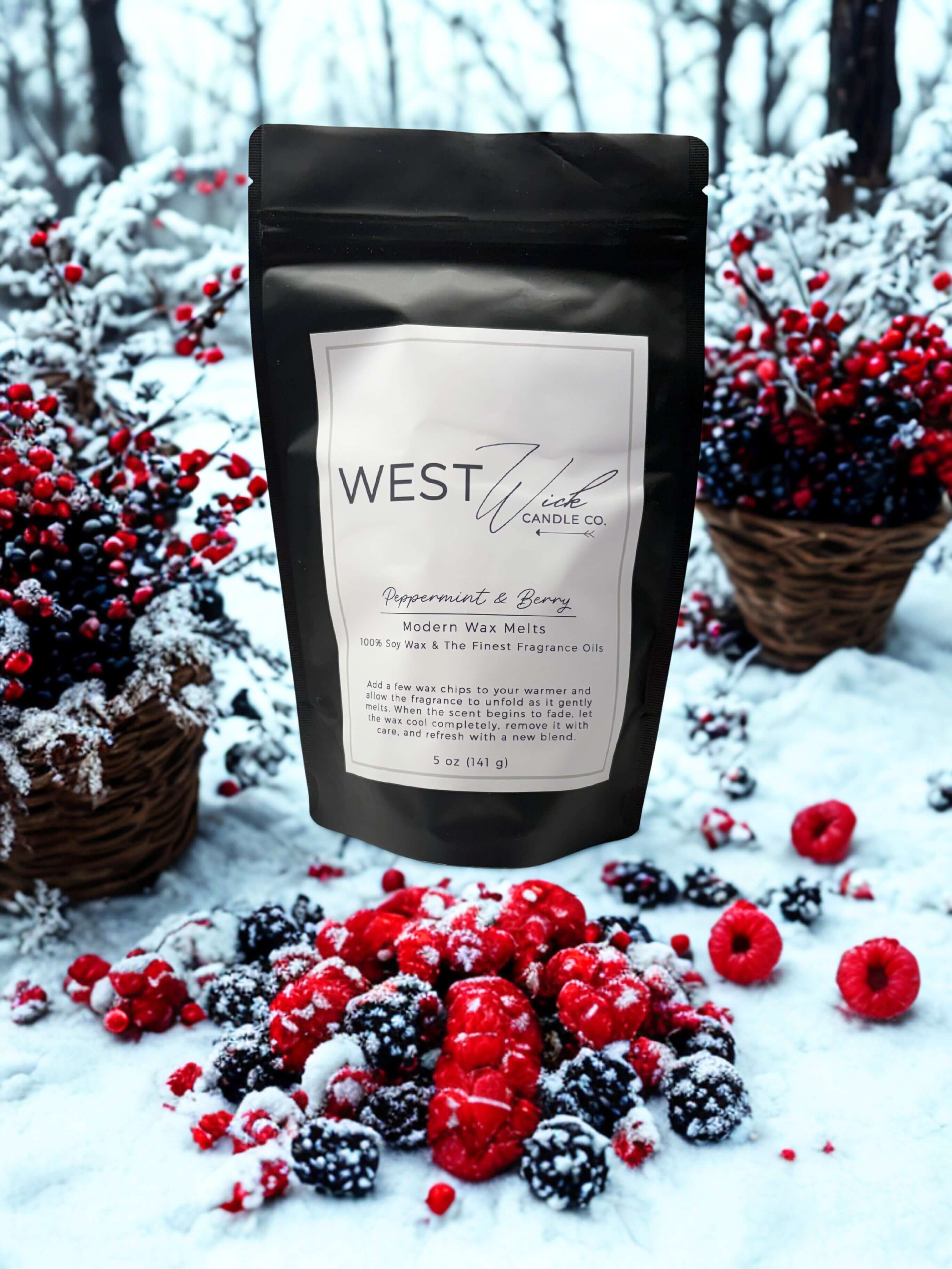 Peppermint & Berry Wax Melts package surrounded by winter berries and snow, enhancing the festive holiday ambiance.