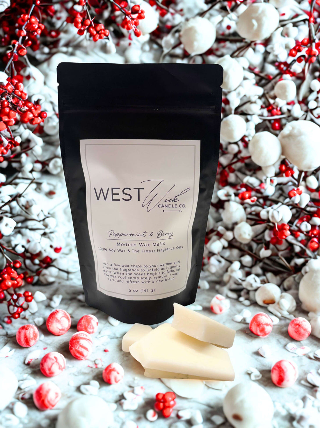 Peppermint &amp; Berry Wax Melts in a package surrounded by festive berries and peppermint candies.
