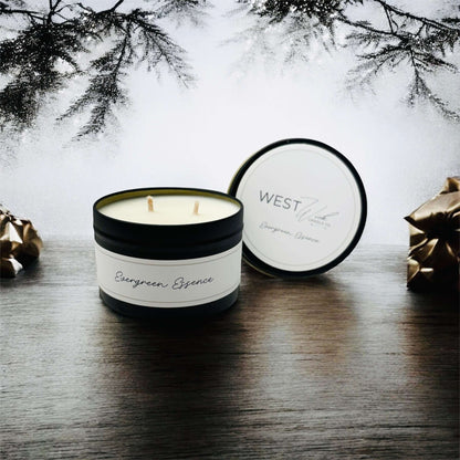 Evergreen Essence - Black Luxe Candle displayed in a cozy winter setting with festive decorations.