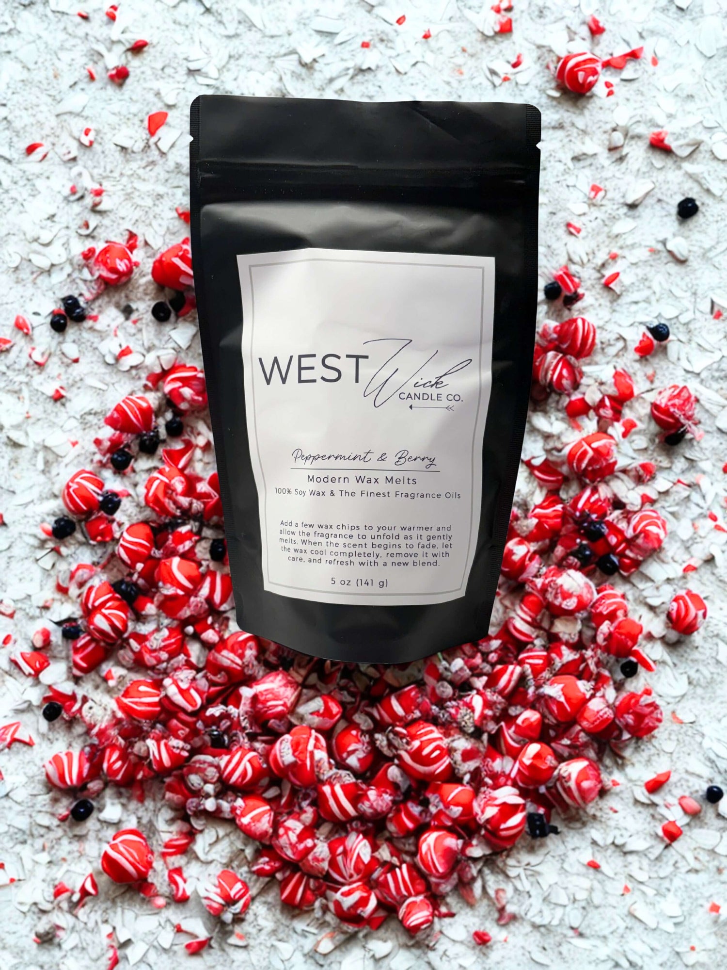 Peppermint &amp; Berry Wax Melts package surrounded by colorful wax pieces, promoting holiday fragrances and festive aromas.