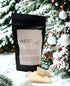 Evergreen Essence Wax Melts packaging displayed in a snowy evergreen forest setting with wax melts in front.