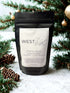 Evergreen Essence Wax Melts by WEST WILD Candle Co in a black pouch with festive pine branches.